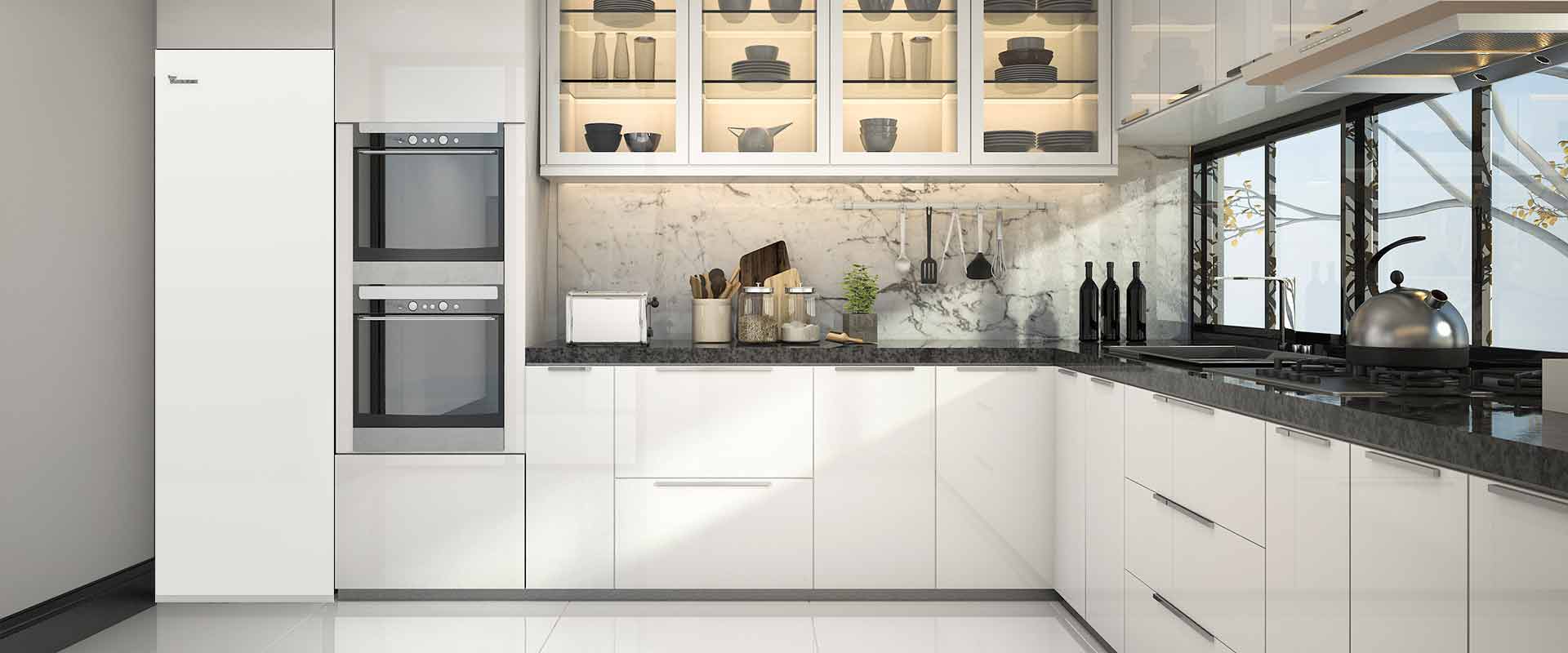 A modern kitchen unit can be seen with smooth and silky looking cupboards and two ovens. To the right of the ovens, there is the ongoing work surface with glass cupboards above, a stove, a sink, and windows on the very right. On the left, there is the brine/water-heat pump WSV built into the kitchenette.